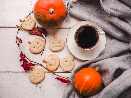 Happy Thanksgiving. Ripe pumpkins, autumn leaves and a cup of hot coffee. Preparing for the holidays. View from above, close-up. Congratulations to loved ones, family, relatives, friends, colleaguesの写真素材