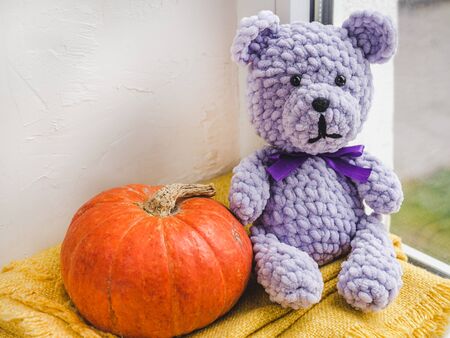 Bright plush toy sitting on a windowsillの写真素材