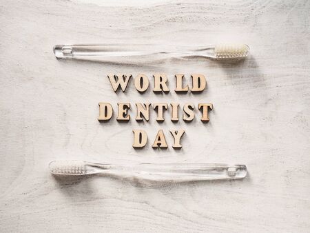 Dentist's day greeting card. White, isolated background, close-up, view from above, wooden surface. Congratulations for relatives, friends and colleaguesの写真素材