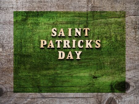 Wooden letters of the alphabet in the form of the words St. Patrick's Day lying on the table. View...