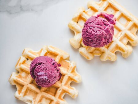 Homemade ice cream and fragrant waffles, lying on the table. Close-up, view from above. Tasty and healthy eating conceptの写真素材