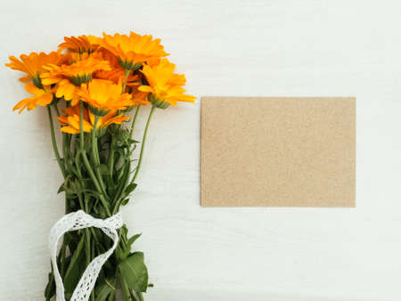 Beautiful, bright wildflowers lying on a white, wooden table. View from above, close-upの写真素材