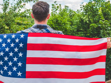 Man holding an American Flag . National holiday
