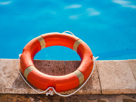 Lifebuoy lying on the background of the pool