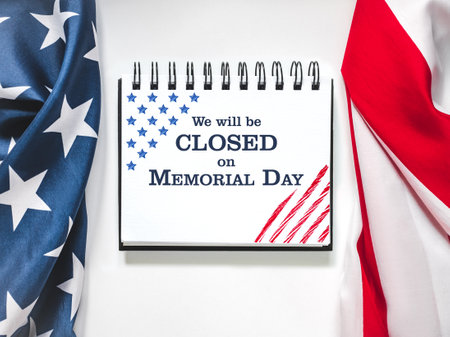 We will be closed on Memorial Day. American Flag and sign board with the inscription. Closeup, no people. Congratulations for family, relatives, friends, colleaguesの写真素材