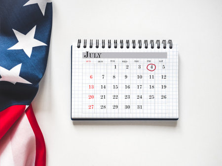 Happy Independence Day. American flag and calendar with the date of July 4th. Calendar marking. Greeting card. Studio shot. Congratulations for family, loved ones, relatives, friends and colleaguesの写真素材