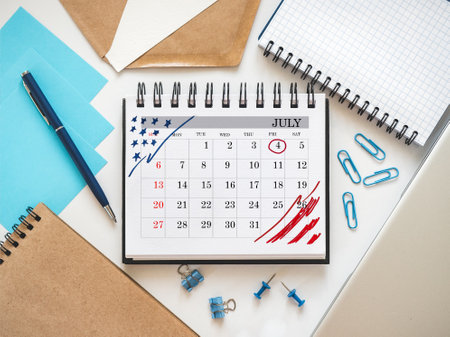 Happy Independence Day. Calendar with the date of July 4th, lying on the table. Calendar mark. Greeting card. Studio shot. Congratulations for family, loved ones, relatives, friends and colleaguesの写真素材