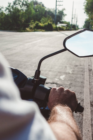 Attractive man riding a motorcycle. Sunny, clear day. Close-up, outdoors. Vacation and travel conceptの写真素材