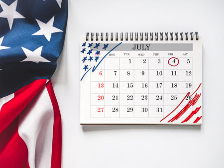 Happy Independence Day. American flag and calendar with the date of July 4th. Calendar marking. Greeting card. Studio shot. Congratulations for family, loved ones, relatives, friends and colleaguesの写真素材