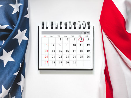 Happy Independence Day. American flag and calendar with the date of July 4th. Calendar marking. Greeting card. Studio shot. Congratulations for family, loved ones, relatives, friends and colleaguesの写真素材