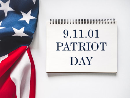 Patriot Day. We will never forget. American flag and lettering. Closeup, isolated background. Studio...