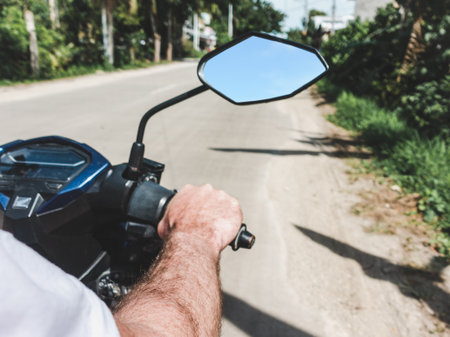 Attractive man riding a motorcycle. Sunny, clear day. Close-up, outdoors. Vacation and travel conceptの写真素材