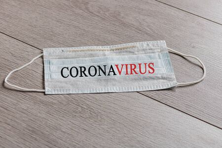 Medical disposable face masks with the inscription Coronavirus applied on them. Covid-19 -  New Coronavirus Pneumonia. Protective mask for breathing.Pandemic.の写真素材