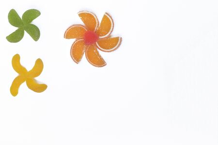 Multi-colored slices of fruit marmalade laid in the form of flowers.の写真素材