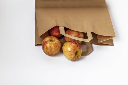 Kraft paper bag brown with apples on a white background, an empty paper bag for packaging products. Environmental protection. Eco conceptの写真素材