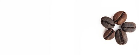 Shiny freshly roasted coffee beans folded in the form of a flower on a white background. Isolated.の写真素材