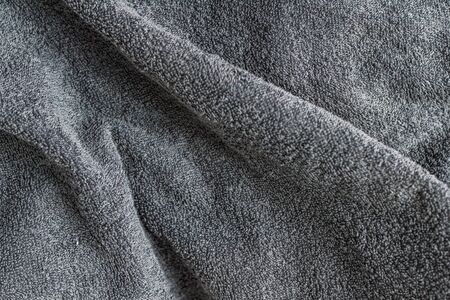 Grey background texture of Terry towel fabric, wavy folds.の写真素材