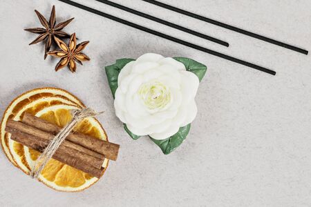 Incense sticks with stand, sliced in orange circles in a wooden bowl and anise star, cinnamon sticks...