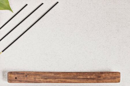 Incense sticks with a stand on a gray background. Aromatherapy. Spa home concept.の写真素材