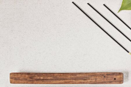 Incense sticks with a stand on a gray background. Aromatherapy. Spa home concept.の写真素材