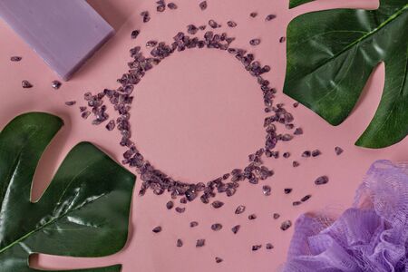 Natural organic cosmetic products with Monstera leaves on a pink background. Flat lay, top view, copy space. The concept of skin care and beauty. Spa home concept.の写真素材