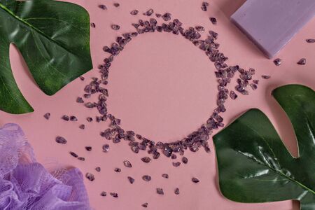 Natural organic cosmetic products with Monstera leaves on a pink background. Flat lay, top view, copy space. The concept of skin care and beauty. Spa home concept.の写真素材