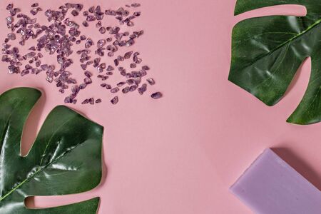Natural organic cosmetic products with Monstera leaves on a pink background. Flat lay, top view, copy space. The concept of skin care and beauty. Spa home.の写真素材