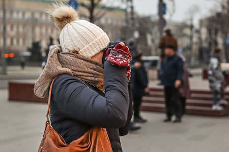 Young woman takes pictures on camera at New Year market.の写真素材