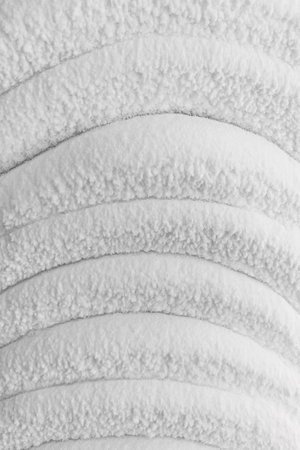 White embossed walls of ice and snow in a cave. Abstract textured natural background