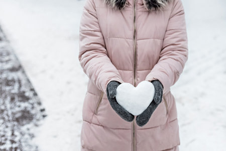 Portrait of a young woman in warm winter clothes outdoors while traveling. Winter time, snow.の写真素材