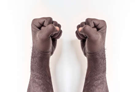 Male hands clenched into a fist on a white background. A symbol of the struggle for the rights of...