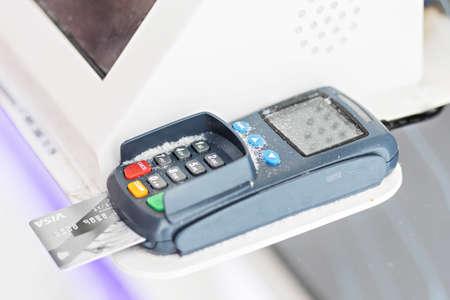 Payment using a debit credit bank card via a payment terminal.のeditorial素材