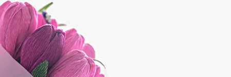 A bouquet of flowers from colored corrugated paper in the form of tulips with a candy inside. Gift, a sign of attention for a holiday, birthdayの写真素材