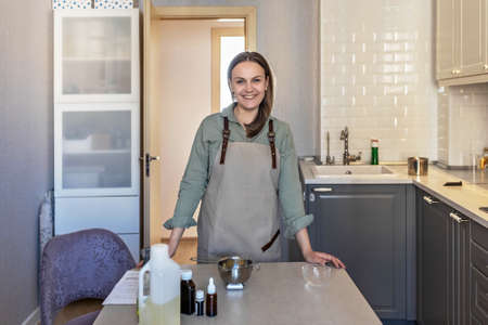 Woman soap-maker prepares ingredients for preparation of body skin care cosmetics. Cooking process. Home spa. Small business.の写真素材
