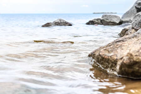 Granite stones in the water on the shore of the Gulf of Finlandの写真素材