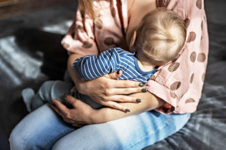 A young woman is breastfeeding her little son. Breastfeeding, motherhood. Family.
