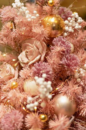 Christmas background from a pink Christmas tree decorated with New Year's pink toys. Winter holidays.の写真素材