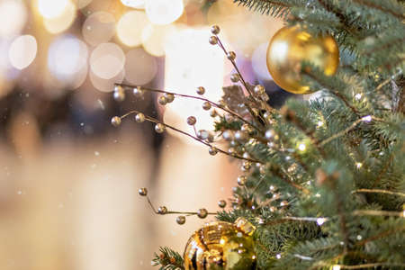 Christmas background from a Christmas tree decorated with New Year's toys on the street. Snow, winter holidays.の写真素材