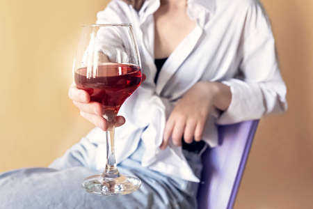 Portrait of a young woman with a glass of red wine in her hands. Spring. Mood.の写真素材