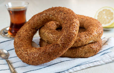 Traditional Turkish breakfast of round bagel - simit with sesame seeds and Turkish tea