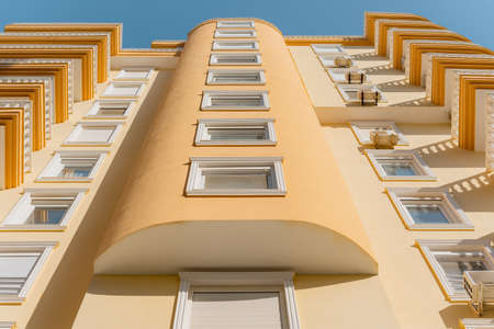 Low angle view of a residential building in orange. European architecture.