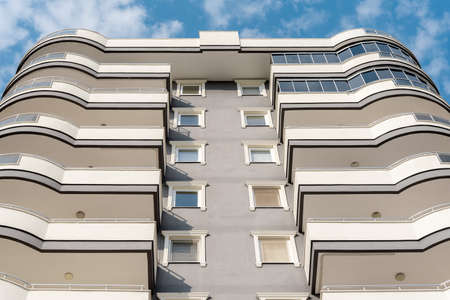 Low angle view of an apartment building with balconies. residential real estate.