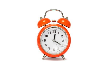 Red alarm clock in the old style, isolated on a white background.