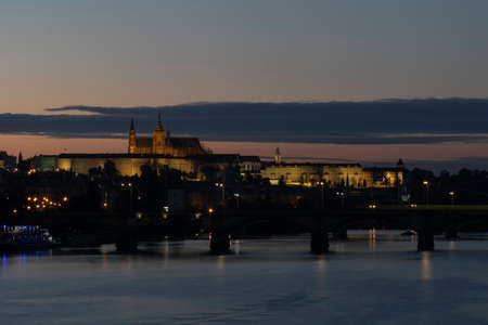 St. Vitus Cathedral and Prague Castle in the center of Prague at sunset in summer. colorful sky and in the sky there are clouds and reflections of light on the surface of the Vltava riverのeditorial素材