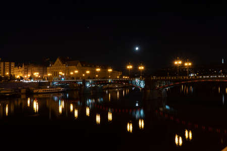 lit street light in a city street at night. glowing lamp at night in the old town of prague in the czech republicの写真素材