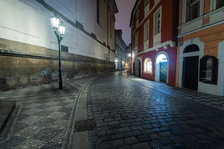 empty illuminated street and cobblestones on the ground in the center of the old town of Prague in lockdown 2021の写真素材