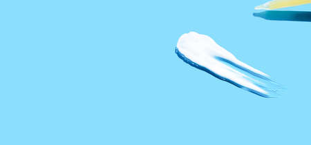 Pipette with dose of fluid hyaluronic acid on blue background. cosmetic concept. flat lay. Place for...