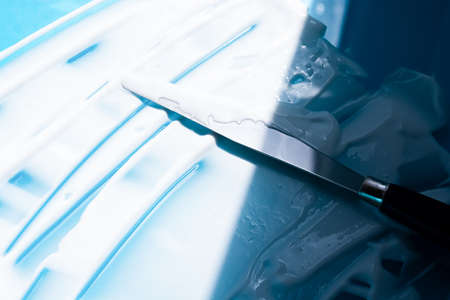 White cosmetic cream diagonal strokes on blue background. Face cream, body lotion, moisturizer...