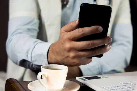 Close-up of doctor using phone at his office, doctor working online, Online consultation....