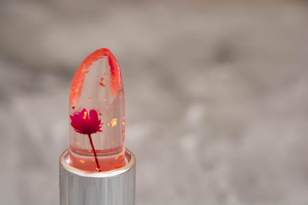 Hot pink color lipstick close up in macro, gray backgroundの写真素材